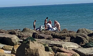 naturist beach videos - Boat full of migrants lands on nudist beach - and naked sunbathers offer  them hot drinks | The US Sun